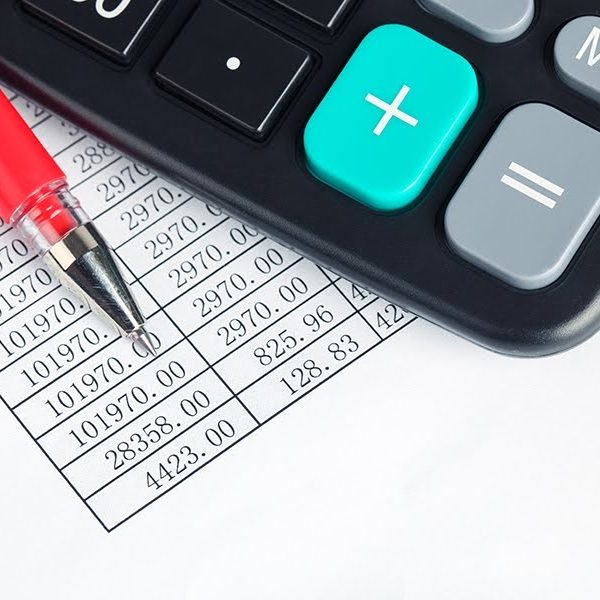 calculator and red pen on a digital report ,financial check concept