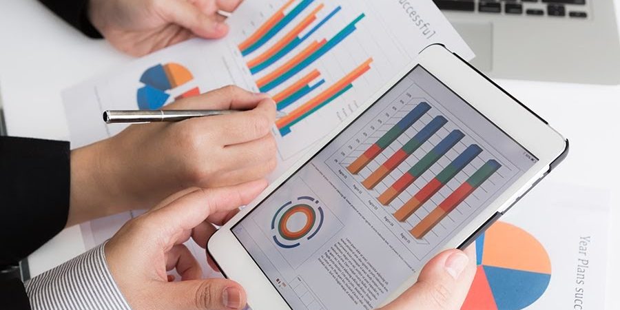 Close-up of  business team using digital tablet with financial diagram
