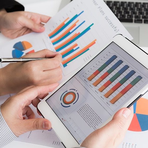 Close-up of  business team using digital tablet with financial diagram
